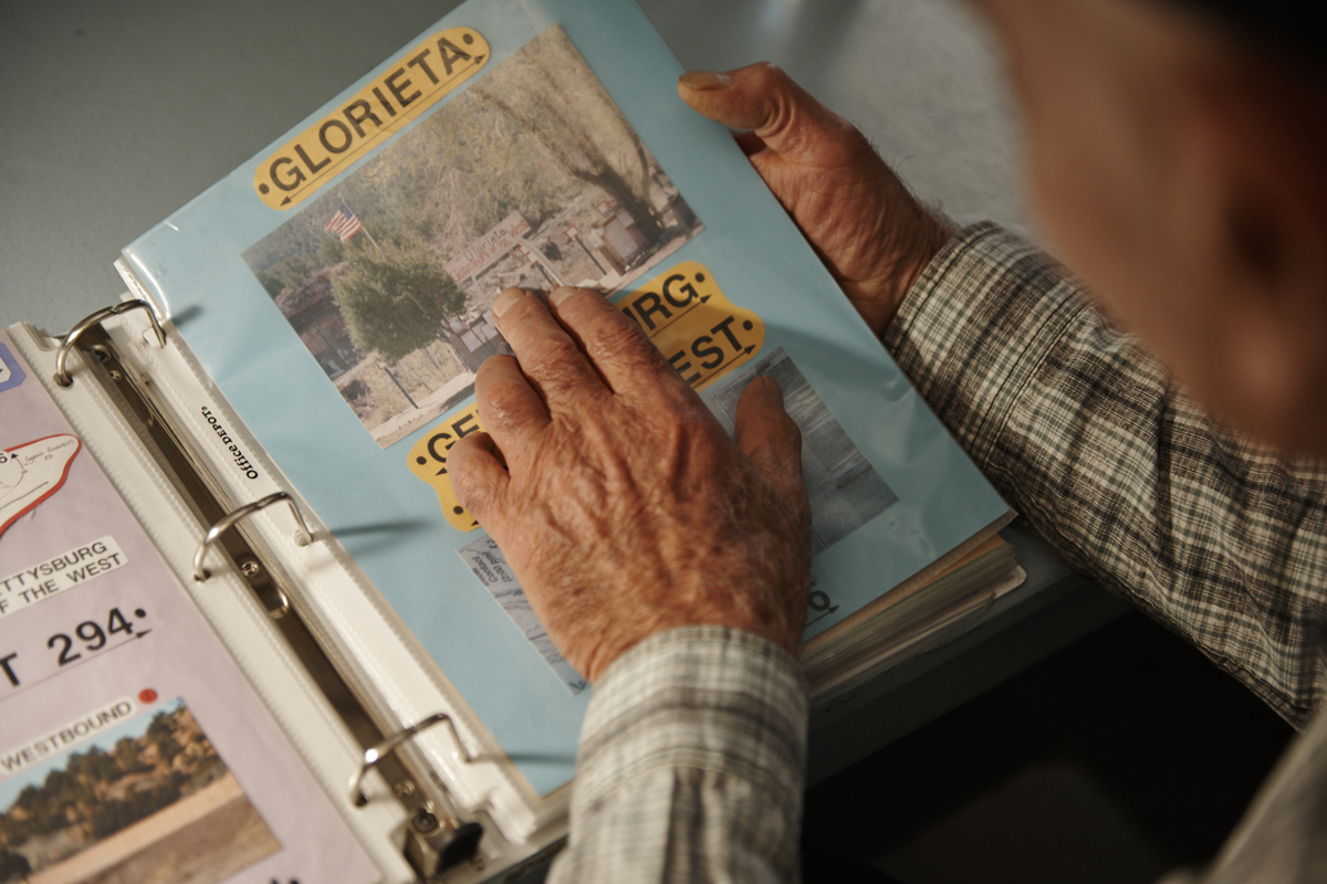 Willie Lambert looks at a collaged page from his extensive Route 66 documentation project. 