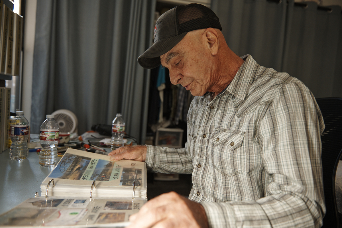 Willie Lambert looks through a binder chronicling miles of the original Route 66 in New Mexico.