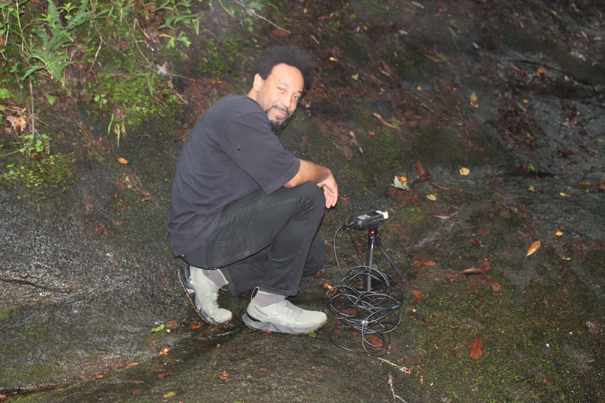 Johannes Barfield, photographed by visual artist Joanna Booth at the Hambidge Center during the summer of 2025, while the arist was recording underwater sounds with a hydrophone at a nearby waterfall.