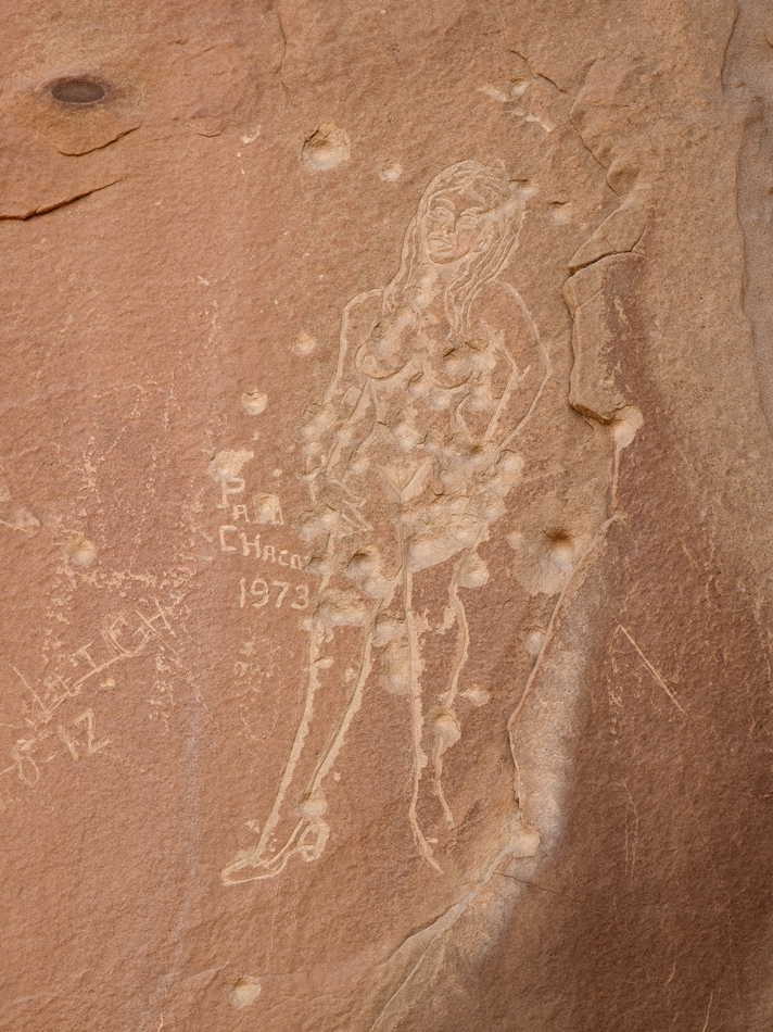 Stone carving with bullet scars from vandalism, by Pacomio Chacon.