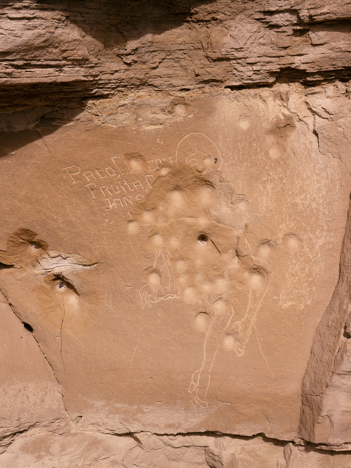 Stone carving with vandalism, by Pacomio Chacon.