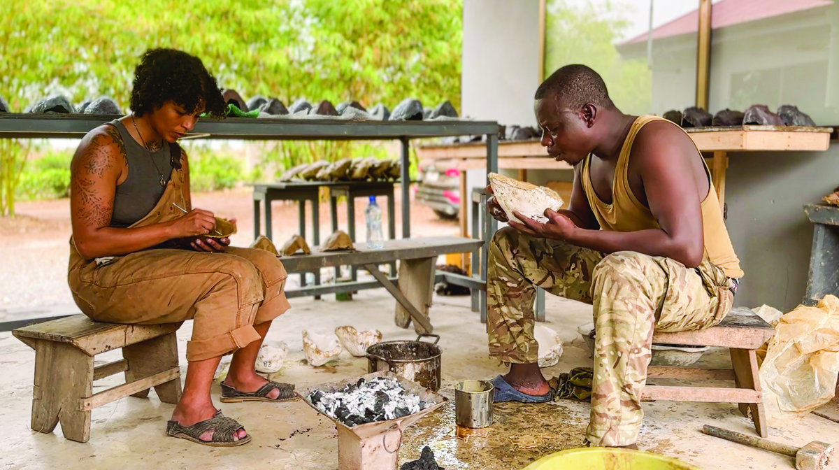 Artists Nikesha Breeze and Ibrahim Allagi Issaka work on a piece.