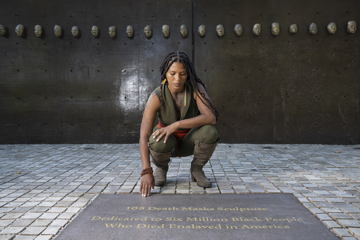 Portrait of artist Nikesha Breeze, who comments on international biennial artists costs.