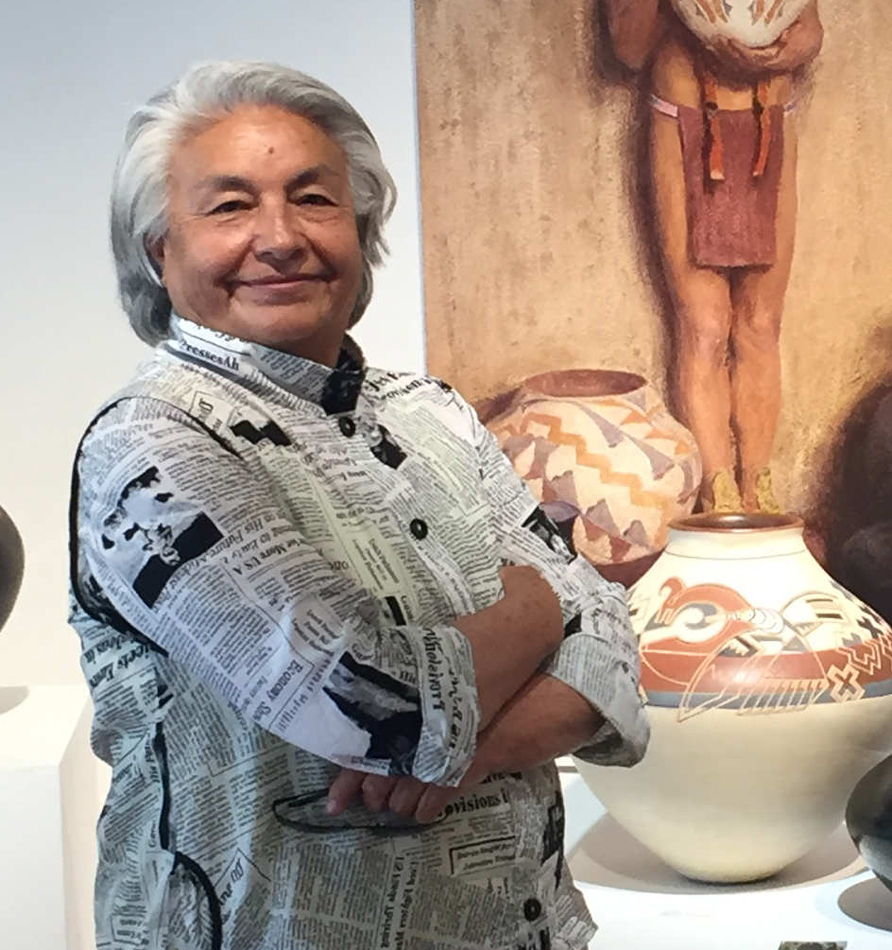 Portrait of Santa Clara Pueblo ceramicist Jody Folwell wearing a shirt with a newspaper print.