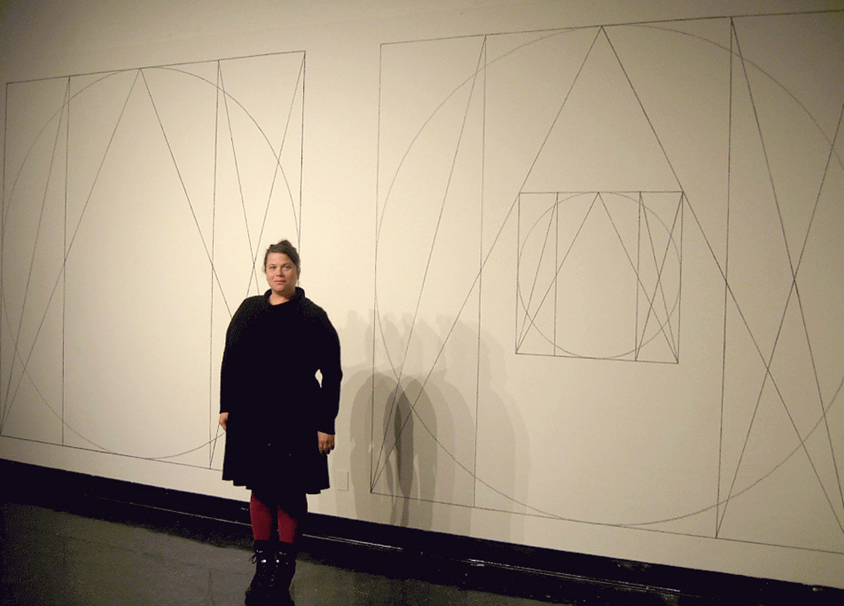 Marisa Sage in front of a Sol LeWitt wall drawing at NMSU Art Museum in Las Cruces, New Mexico.
