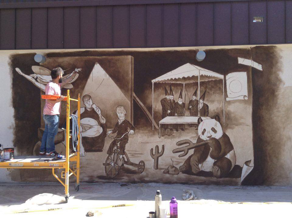 Diego Perez paints a mural in Pheonix. New Phoenix mural guidelines could change the game in Sun Valley.