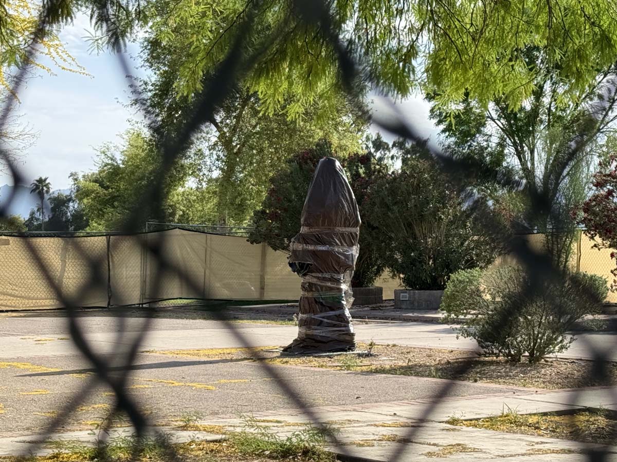 Zarco Guerrera's sculpture of César Chávez fenced in at a Phoenix park, March 2026.