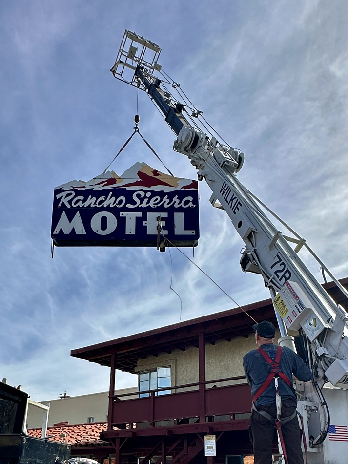 A crane lifts the Rancho Sierra Motel sign in Reno, which now appears at the Light Circus Nevada Neon Museum.