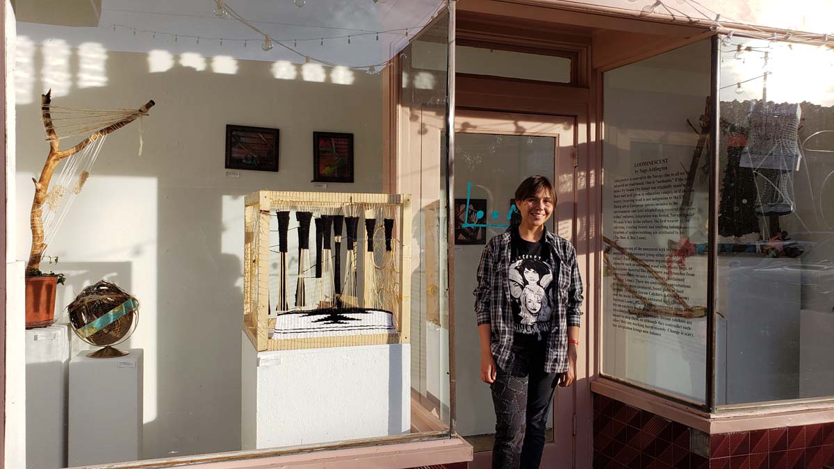 Artist Sage Ahebah Addington (Diné) at the Loom Indigenous Gallery.