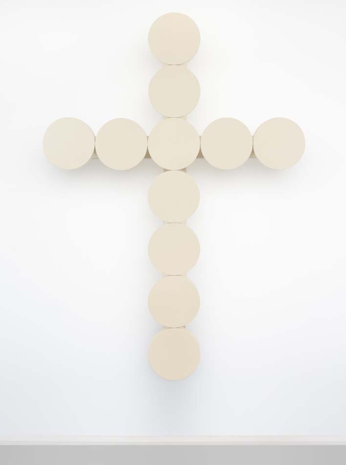 Vanilla Wafer: a white cross made from the seats of prison chairs and pinned to the wall