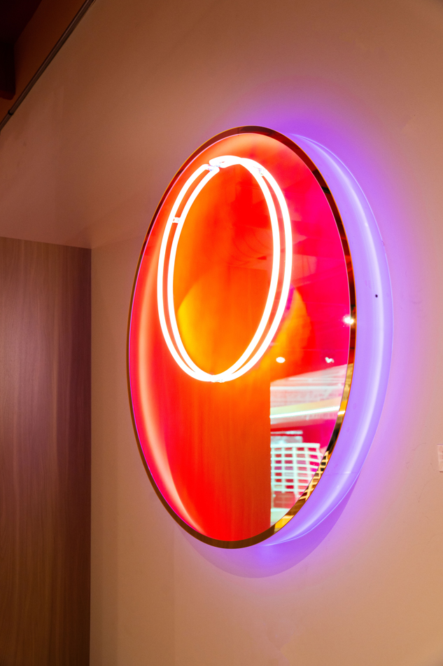 Neon artwork with two concentric circles.
