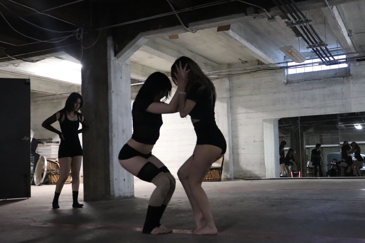 Dancers silhouetted in a subterranean space.