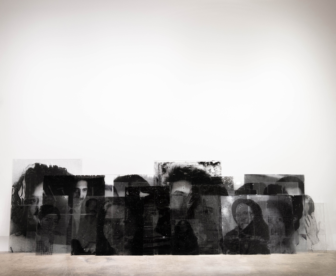 Stacked glass plates with photographic transfers on them.