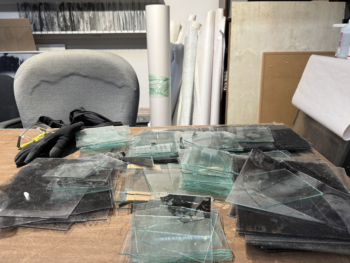Desk with photographic glass plates stacks on it.