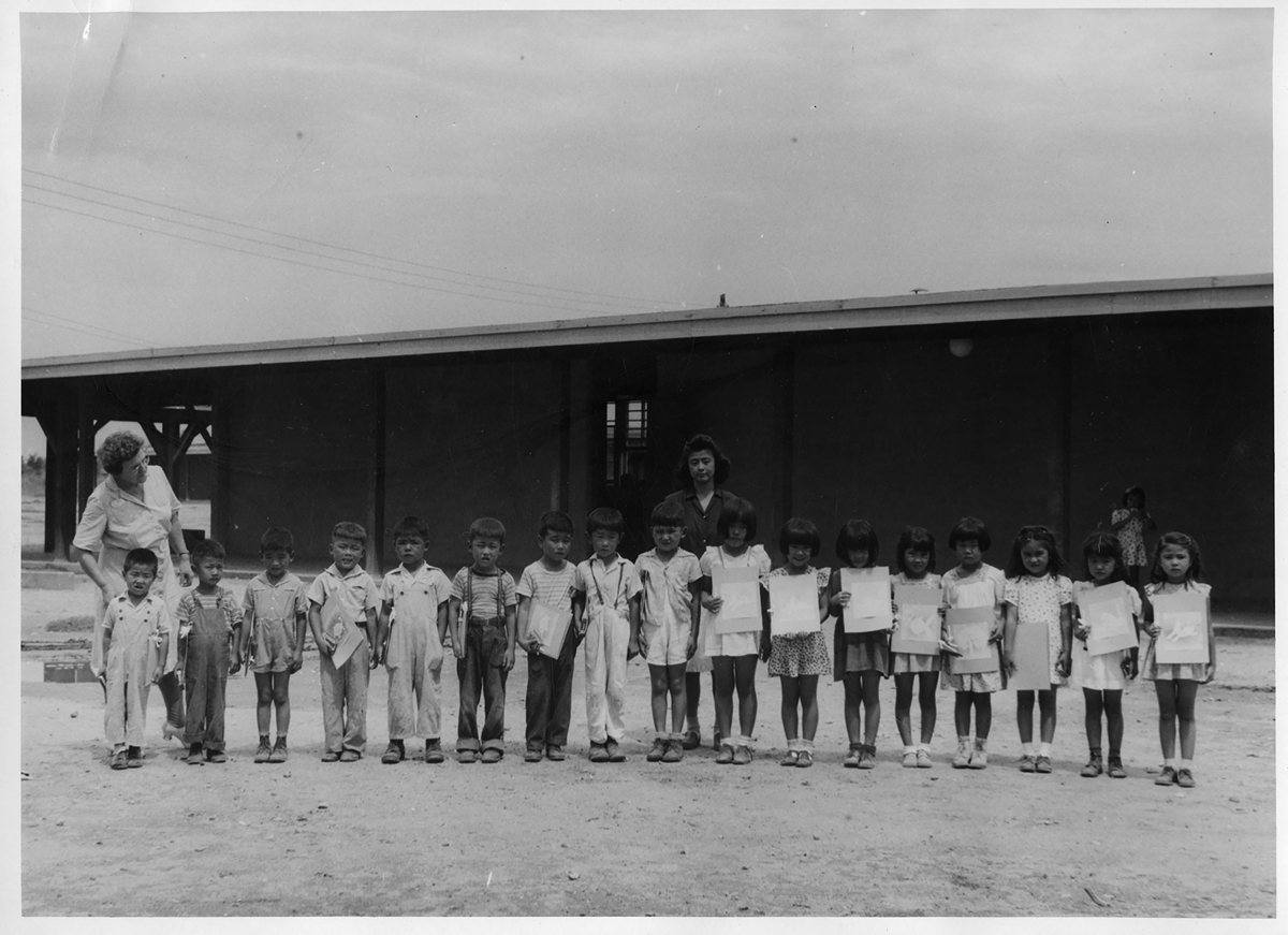 Photo of schoolchildren who were imprisoned in a Japanese American incarceration camp.