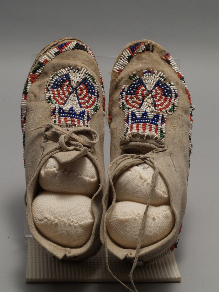 Moccasins from Taos Pueblo with beaded American flags, from the Museum of Indian Arts and Culture.