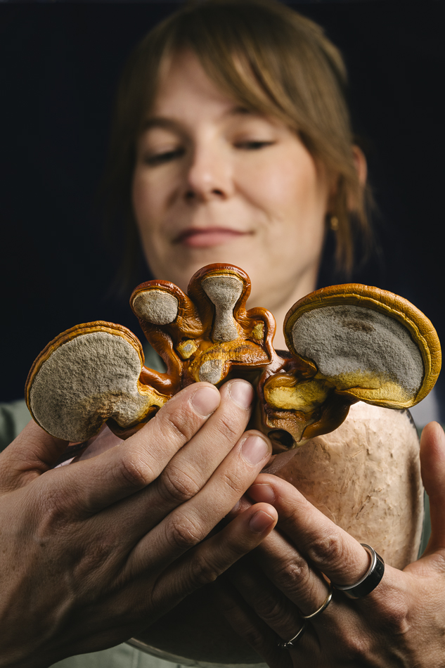 Sculptor Kate Casanova holding mushrooms.
