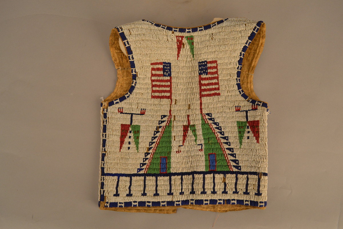 Beaded Lakota vest with American flags on it, at the Museum of Indian Arts and Culture.