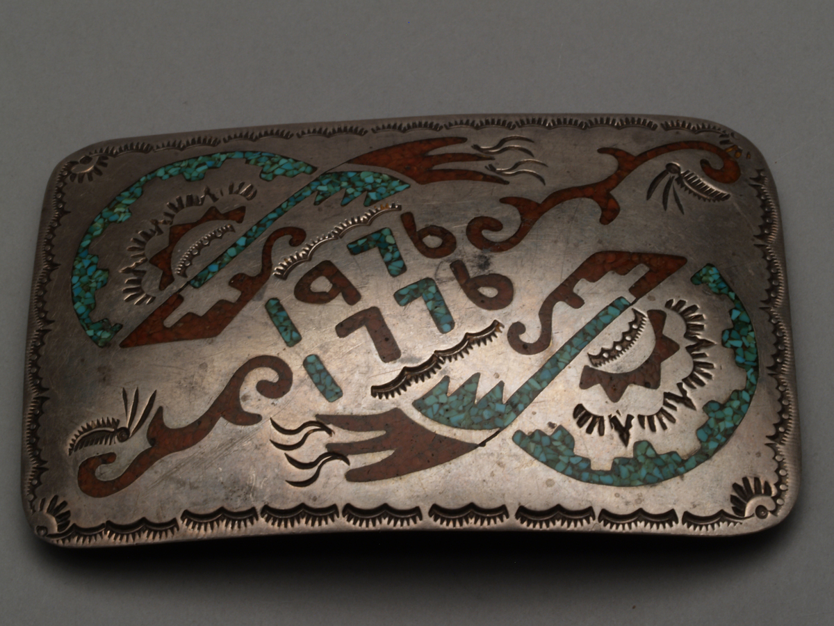 Navajo belt buckle thgat reads "1976 1776" at the Museum of Indian Arts and Culture.