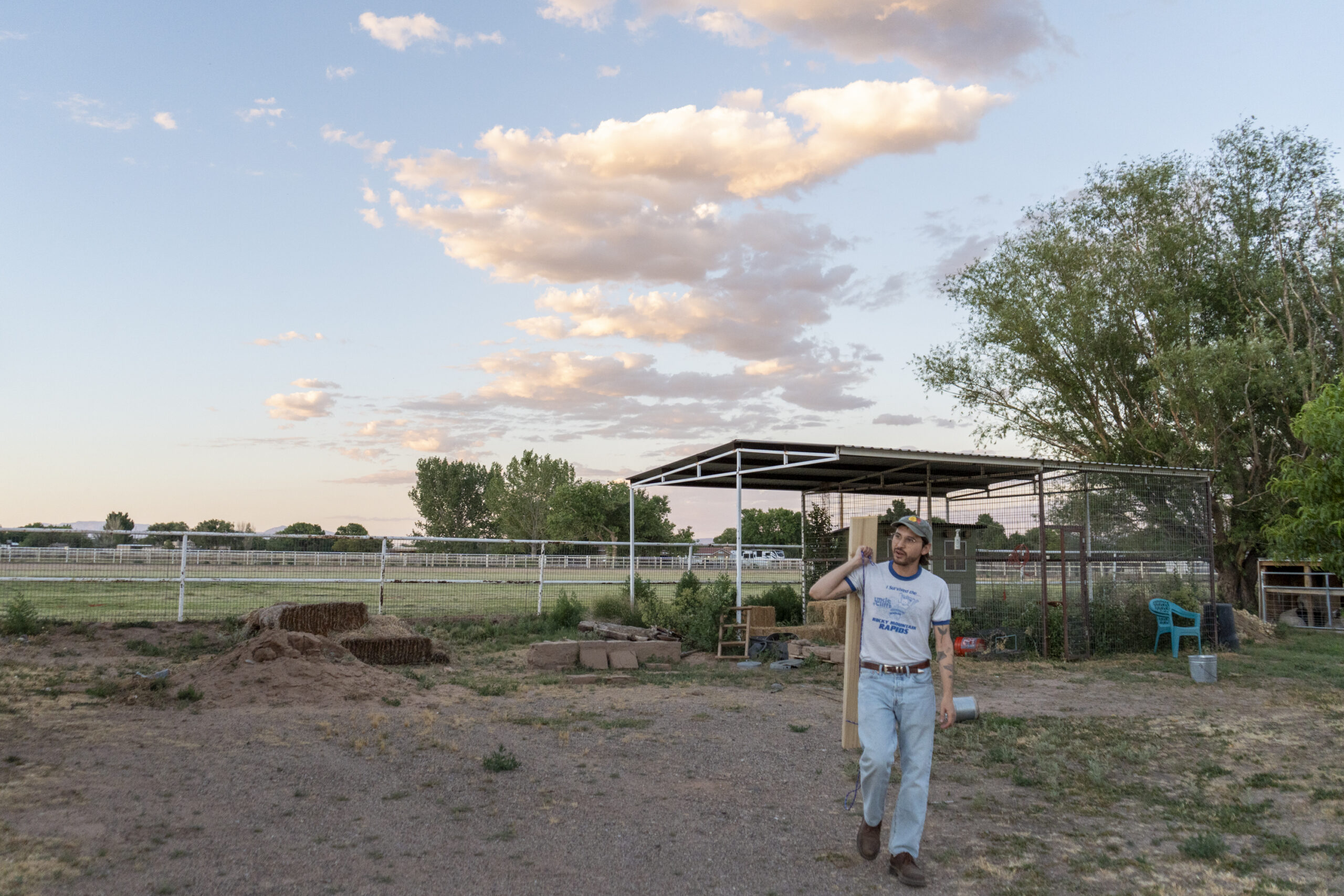Gonzales walks through his family backyard in Los Lunas carrying a handmade crop circle tool.