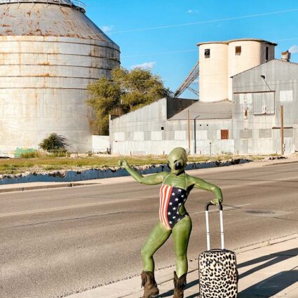 La Pocha Nostra, Hitchhiking Alien, Jess Fitz tries to get a ride in the streets of Roswell, New Mexico.
