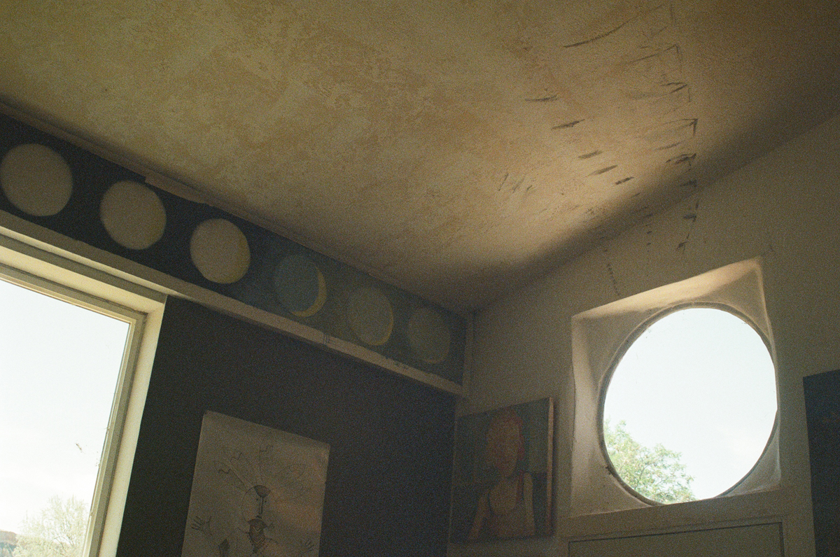 Interior shot of the windows in the studio of deceased Utah artist Joe Pachak. This unconventional obituary covers his life, dissapearance, and the recovery of his body.