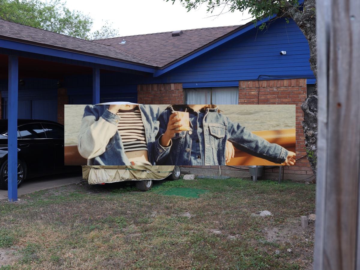 Hyphen-shaped photo of jean-jacketed torsos layered on top of photo of a brick home