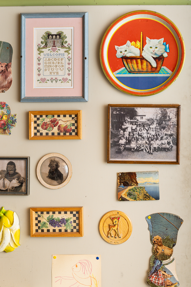 Family and quirky photos displayed on wall.