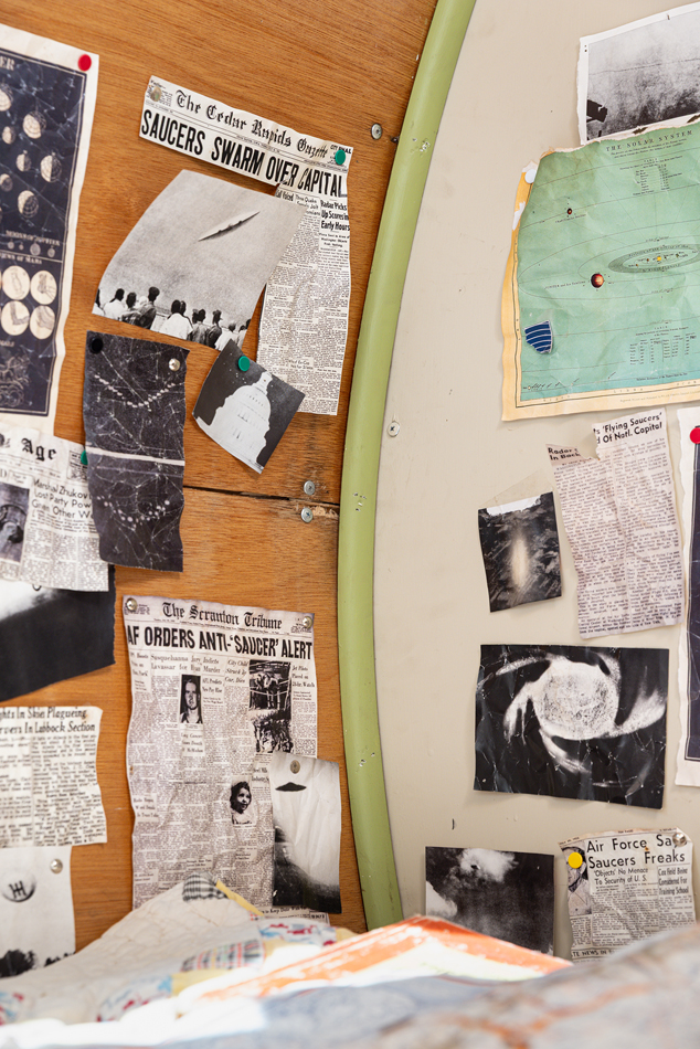 Different newspaper articles hung up on a wall